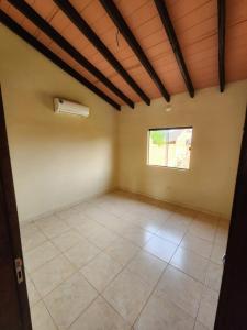 an empty room with a window and a ceiling at Casa Nova aeroporto in Luque