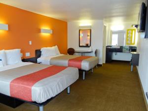 a hotel room with two beds and a desk at Motel 6-Erie, PA in Erie