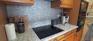 a kitchen with a counter top with a microwave at Maison en Pierre et Colombage à Entraygues in Entraygues-sur-Truyère