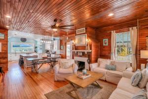 a living room with wooden ceilings and a dining room at Wish Upon a Big Starfish by Tybee Cottages in Tybee Island