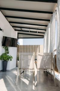 a dining room with two chairs and a table at MHVolos Suites in Volos +20 photos