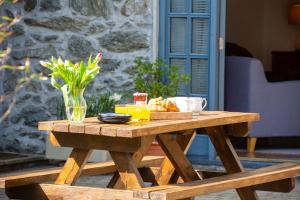 a wooden picnic table with a plate of food on it at Y Fran in Llangefni