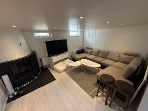 a living room with a couch and a tv at Fredholmens Apartment in Gothenburg