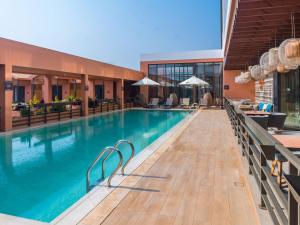a pool at a hotel with chairs and tables at NOVOTEL KOLWEZI in Kolwezi