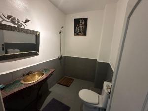 a bathroom with a sink and a toilet and a mirror at Cosy private riad 3 rooms in Marrakech +17 photos