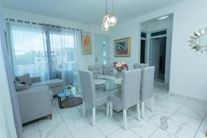 a dining room with a table and chairs at Ventura Living in Nagua