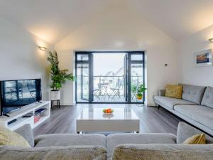 a living room with a couch and a table at 2 Bed in Westward Ho 77289 in Northam