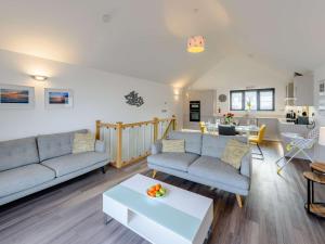 a living room with two couches and a table at 2 Bed in Westward Ho 77289 in Northam