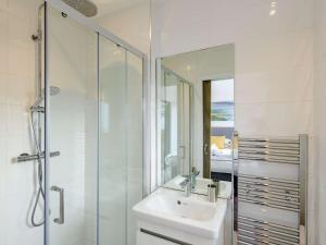 a bathroom with a sink and a glass shower at 2 Bed in Westward Ho 77289 in Northam +16 photos