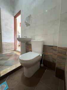a bathroom with a toilet and a sink at Merdeka 19A in Taiping +4 photos
