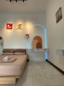 a room with two beds and a table with a mirror at Merdeka 19A in Taiping
