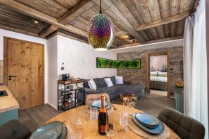 a living room with a table and a couch at Mountain Apartment No 209-CORSO Harrachov, High Speed WI-FI, Ambilight smart TV, Netflix, YouTube, FREE parking, private SEJF, PRIVATE bike storage, HARRACHOVCARD in Harrachov +29 photos