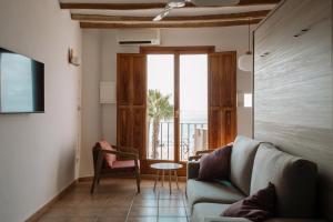 a living room with a couch and a table at Esquerdo 22 by Seaward Suites in Villajoyosa