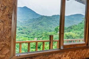 a window with a view of a mountain at Cabaña con vista a Santa Marta in Santa Marta