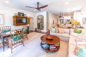 a living room with a couch and a table at Heart of Palms in Blue Gulf Beach