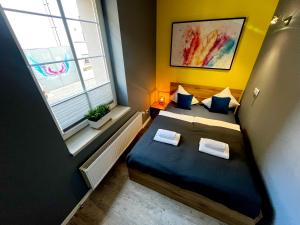 a small room with two beds and a window at Zuzia Apartment - 50 m od Rynku in Racibórz
