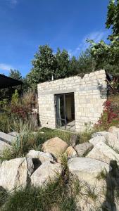 a stone building with rocks in front of it at Family comfort 