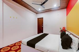 a person sitting on a bed in a room at Hotel O The Blue Heart in Itaunja