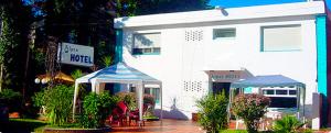 a white building with a tent in front of it at Alpes Hotel in Punta del Este