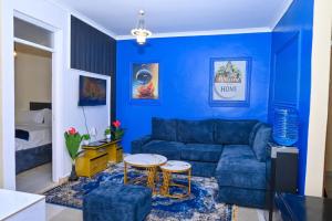 a blue living room with a couch and a table at Two Bedroom Free Wi-Fi and Netflix in Nanyuki on your way to Ol Pejeta Conservancy in Nanyuki