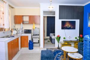 a kitchen and a living room with a table at Two Bedroom Free Wi-Fi and Netflix in Nanyuki on your way to Ol Pejeta Conservancy in Nanyuki