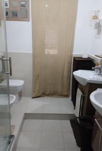 a bathroom with a shower and two sinks and a toilet at Marina's House in La Spezia +9 photos