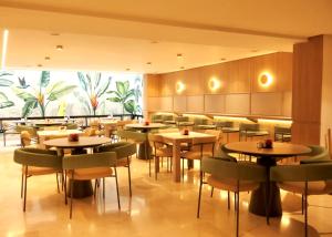 a restaurant with tables and chairs in a room at Obo Hotel in Medellín