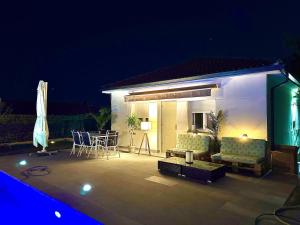 a patio with a couch and a table and chairs at Casa Rural de montaña en Valle de Iruelas y Pantano de San Juan con BBQ in Navahondilla +78 photos