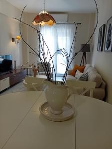 a vase sitting on a table in a living room at CENTRAL SPOT AXD in Alexandroupoli