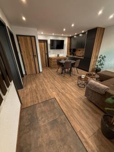 a living room with a couch and a table at Apartmán TatraNest in Nová Lesná