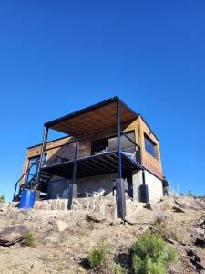 a wooden house on top of a hill at Brisas de la Cayana Cabaña Villa Alpina in Villa Alpina
