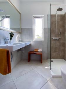 a bathroom with a sink and a shower at Villa Delfin Rab in Supetarska Draga
