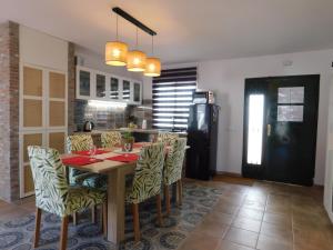a kitchen with a table and chairs and a refrigerator at Casa Linda in Almáchar