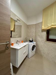 Un baño con lavadora y lavabo. en Appartamento Campo grande, en Cavallino di Lecce 9 fotos más