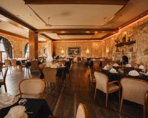 comedor con mesas, sillas y paredes de ladrillo en Chateau Fasel, en Tirana