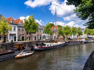 a group of boats are docked on a river at Homestay Room in Utrecht