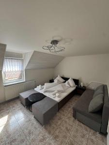 a bedroom with a large bed and a couch at Apartmány LAVANDE in Trávnica