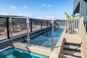 a swimming pool on a balcony with a view of the water at Naomi Boutique Villa with private pool in Netu'a