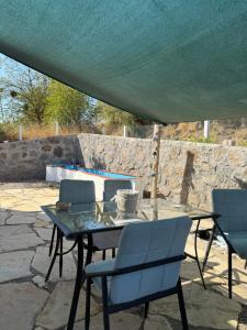 a table and chairs under a tent on a patio at Saman Evim Çiftliği in Sındırgı