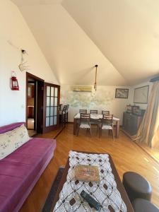 a living room with a couch and a table at MILA Adriatic sea view apartment, Sveti Stefan in Sveti Stefan