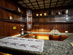 a kitchen with a sink and a counter top at Pousada Dorcas in Ubatuba