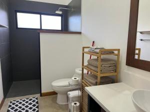 a bathroom with a toilet and a sink at Casa Flor in Playa Avellana +15 photos