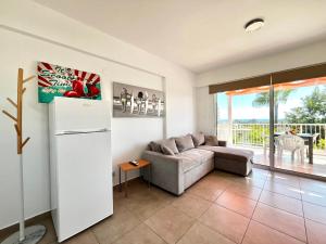 a living room with a couch and a refrigerator at STAY Symphony Apartment in Protaras