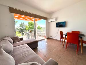 a living room with a couch and a table at STAY Symphony Apartment in Protaras
