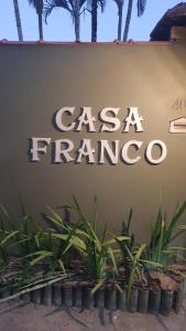 a sign that says casa franca on a wall with plants at Casa Franco Hospedaria in Trancoso