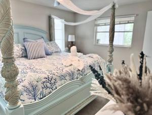 a bedroom with a blue and white bed and a window at Luxury Coastal Retreat in Largo