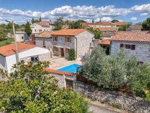 a villa with a swimming pool in a village at Casa Tereza in Mrgani