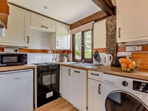 a kitchen with white cabinets and a dishwasher at 1 Bed in Bude WBARN in Sutcombe +16 photos