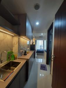 a kitchen with a sink and a counter top at Pollux Habibie Studio Deluxe 2 sea view, Netflix by Superstay in Batam Center