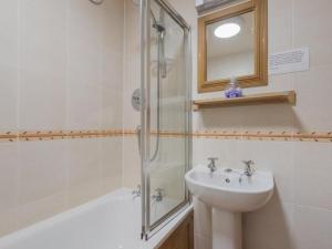 a bathroom with a sink and a shower at 3 Bed in Water Yeat SZ079 in High Nibthwaite +7 photos